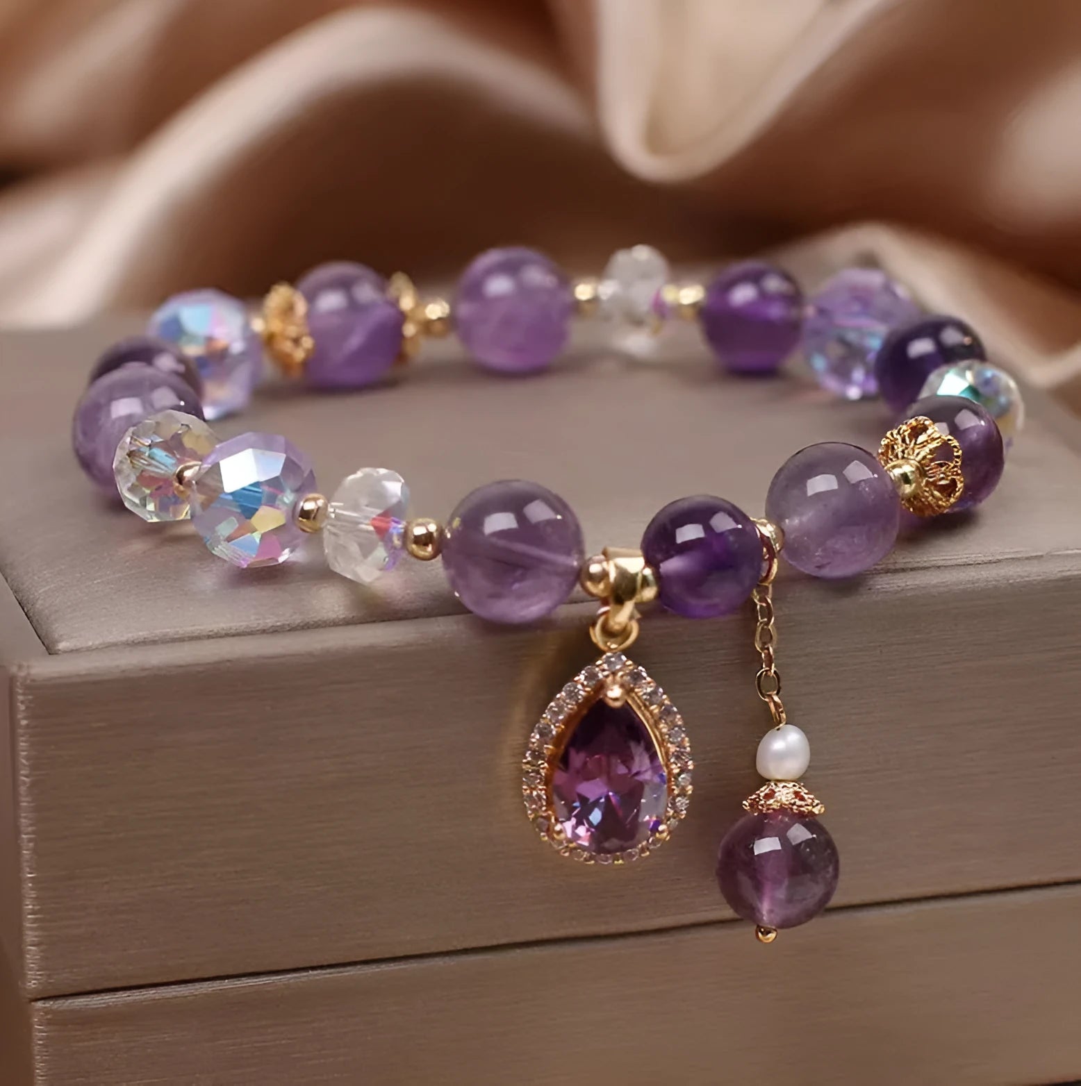 Close-up of a women's purple amethyst crystal bracelet with detailed micro inlay stone setting.