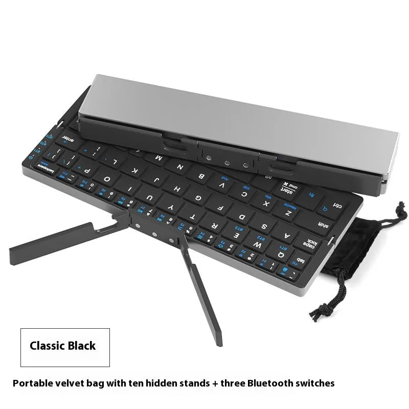 Folding Bluetooth keyboard in black gray for tablets and phones on a plain background
