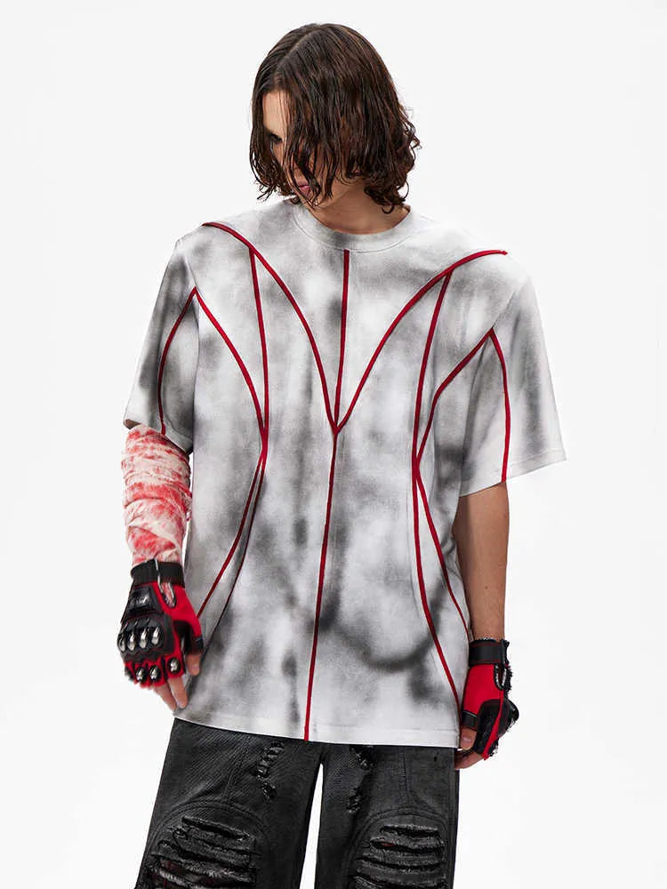 Women's padded shoulder T-shirt with textured line patchwork detail on the front.
