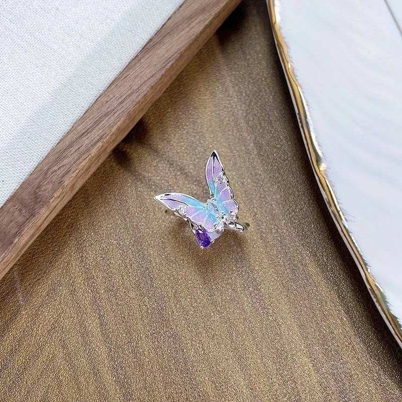 Copper adjustable insect ring with dripping oil finish in jewellery display