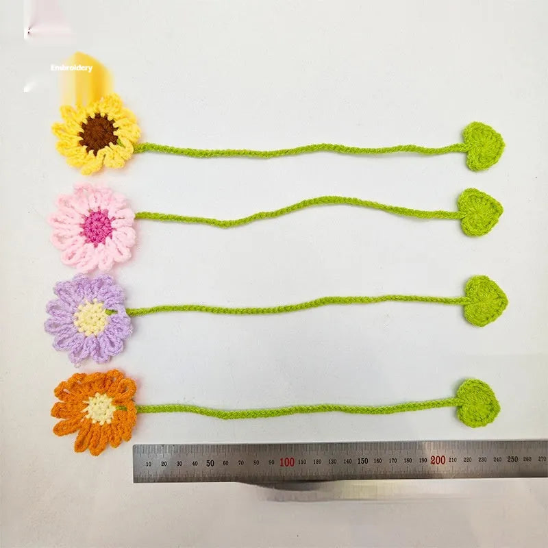 Hand-crocheted wool bookmark with flexible wire core and little daisy design in milk cotton yarn