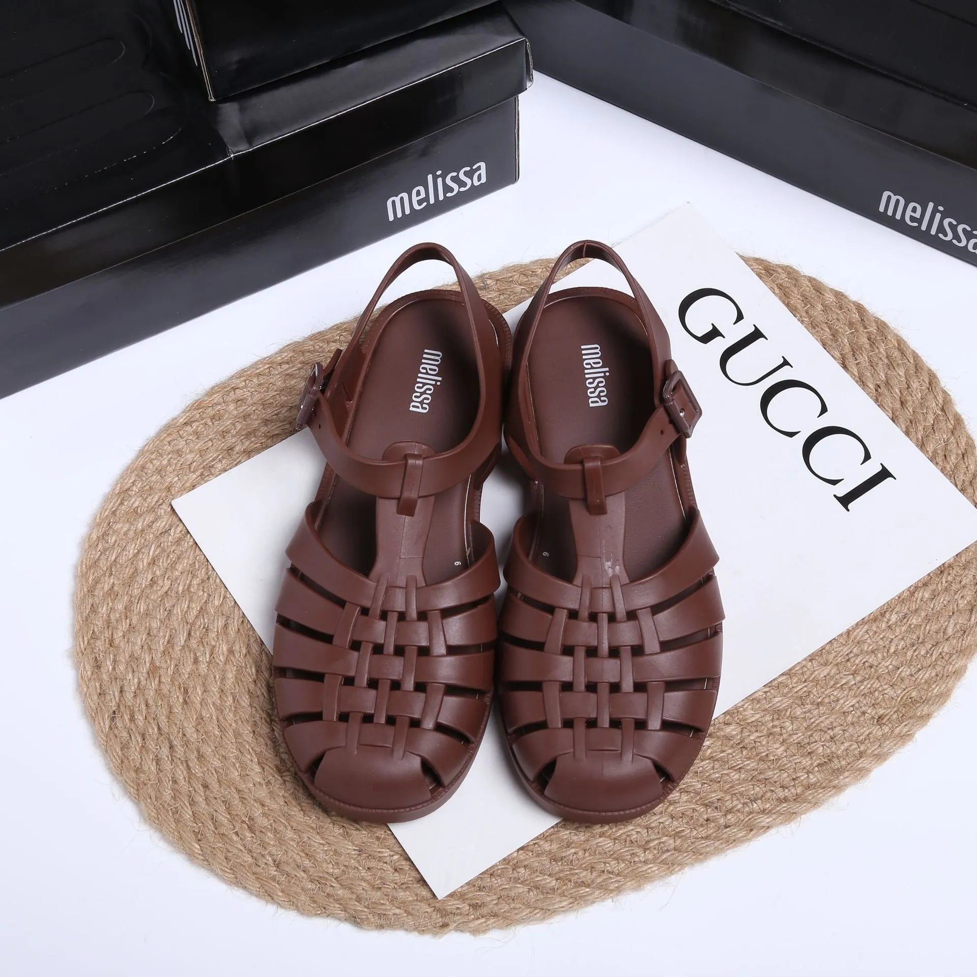 Matte black Roman sandals with vintage weave pattern and buckle closure