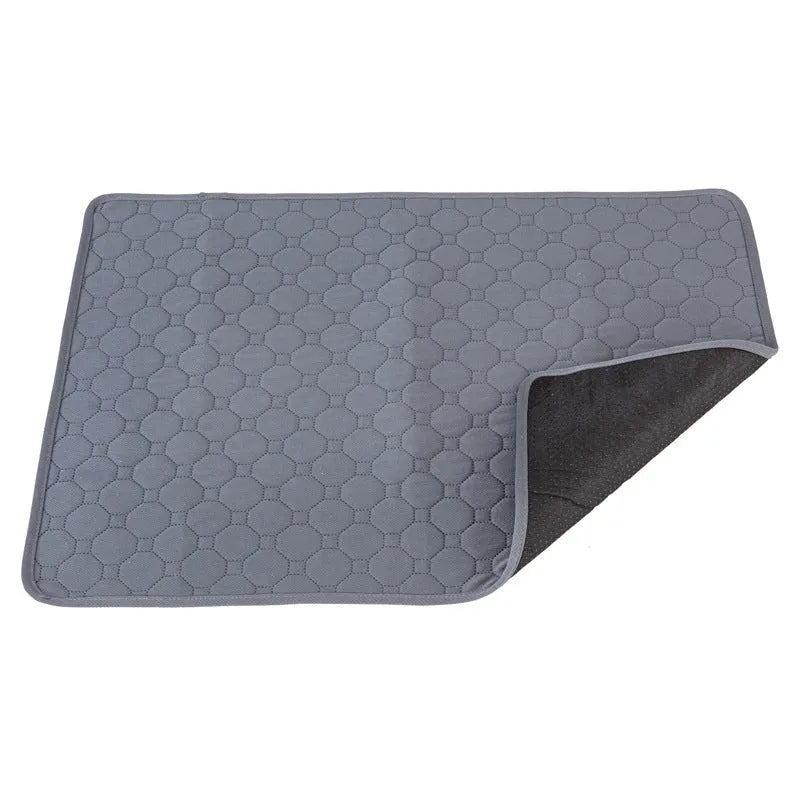 Pet Parents grey and khaki washable dog pee pads in multiple sizes on a wooden floor.