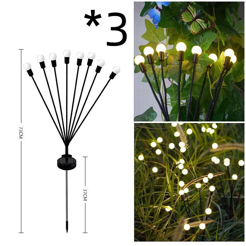 Solar-powered LED firefly lawn light with ground stake inserted in grass