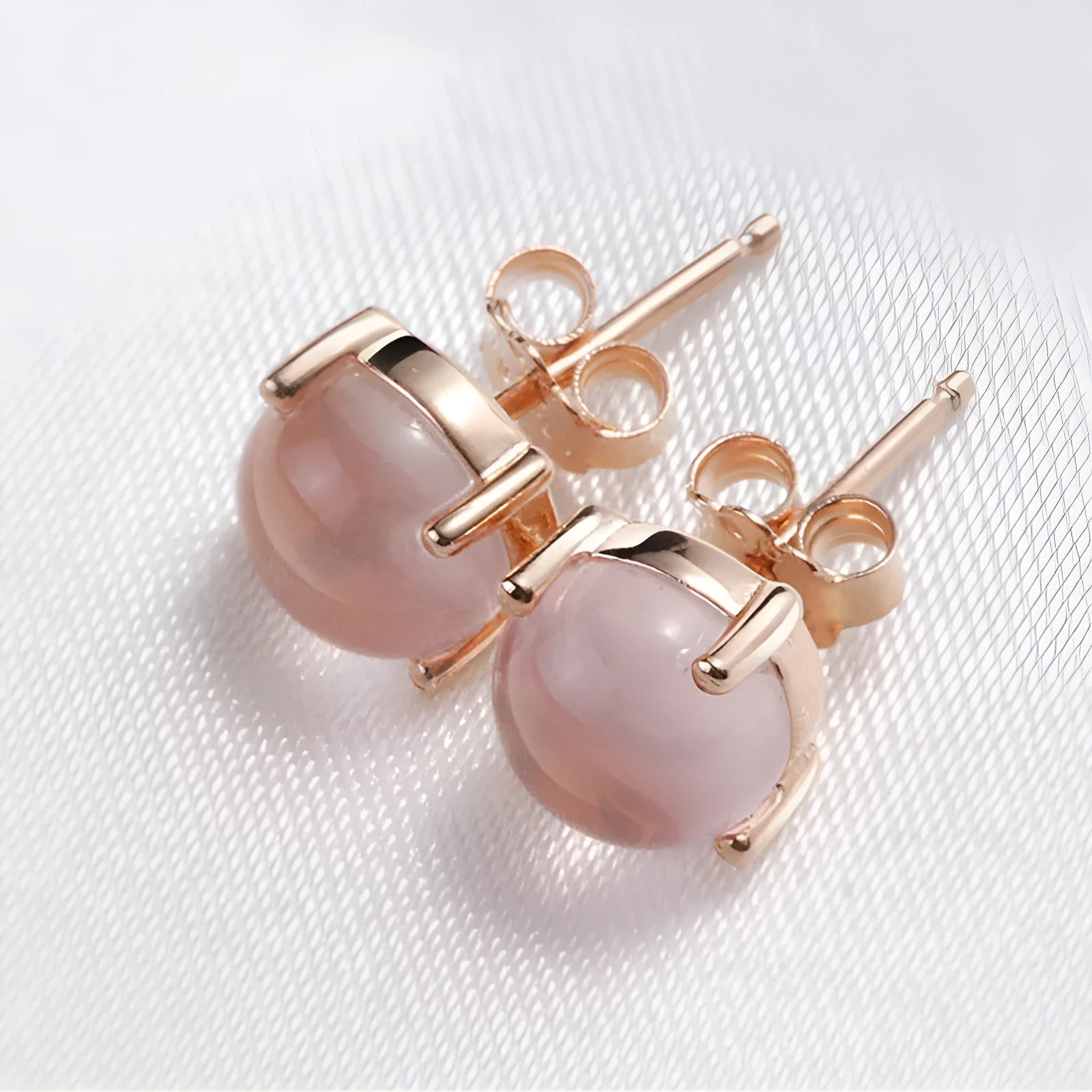 Rose gold coloured drop shaped stud earrings with synthetic ross quartz crystal inlay, Korean style design
