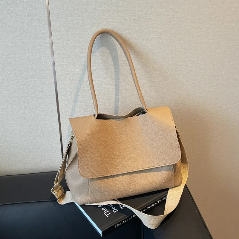 PU leather tote bag in beige with double shoulder strap and visible stitching detail.