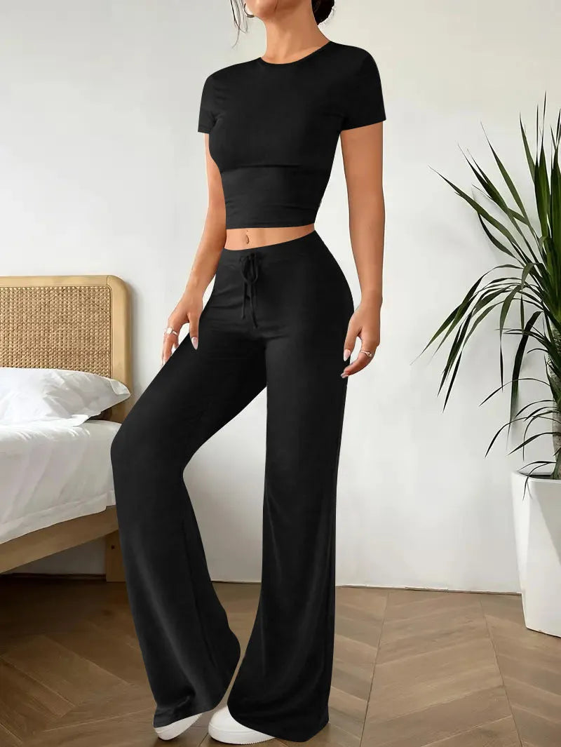 Black high waist trousers and short sleeve t-shirt matching set laid flat showing coordinated outfit