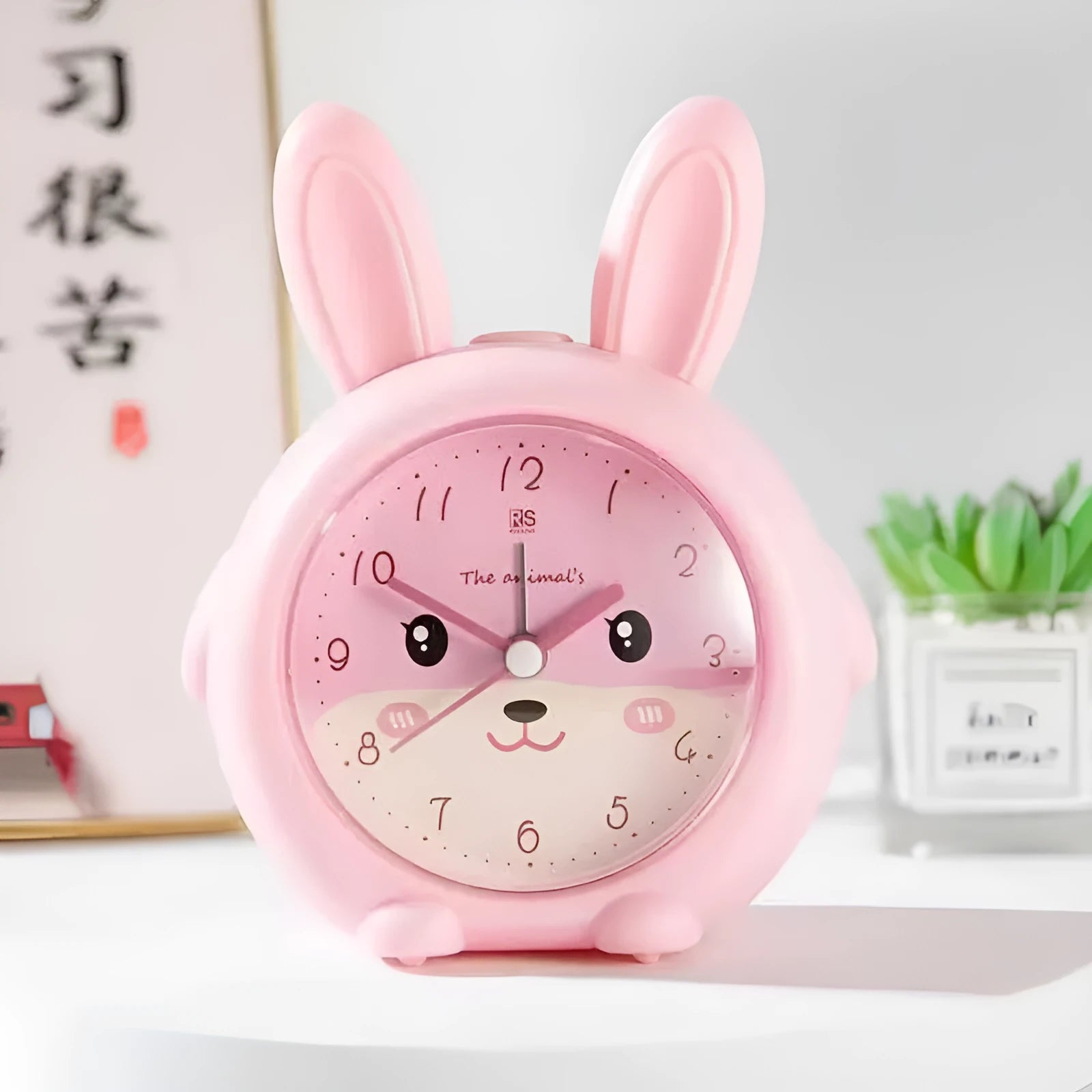 Children's cartoon style alarm clock with singing function, night light, and multiple alert modes in pink and blue colours