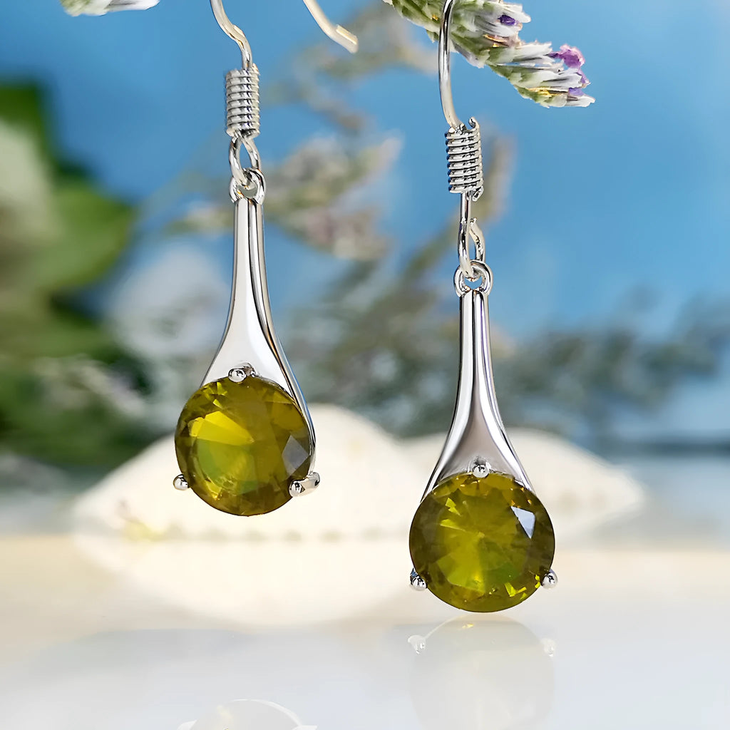 Olive green topaz coloured alloy drop earrings in a water drop shape on a white background.