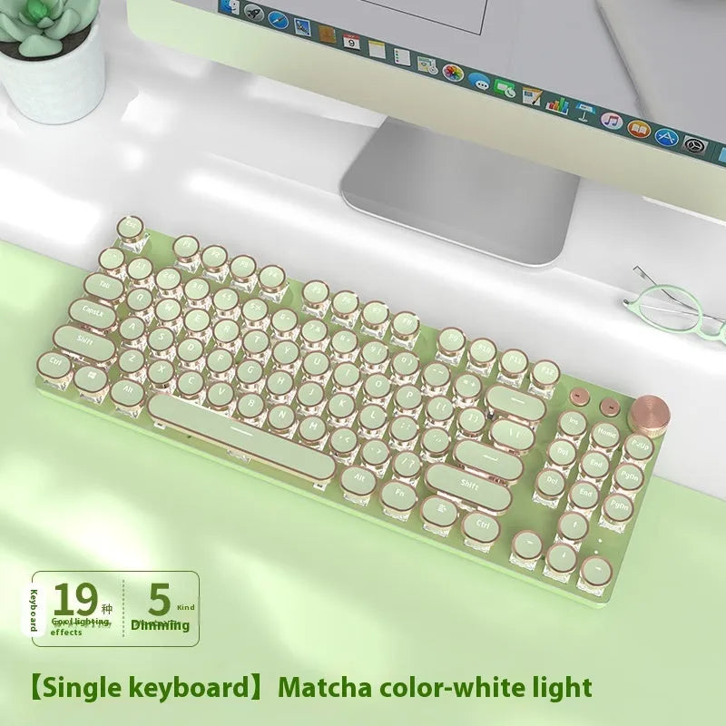 Matcha green mechanical gaming keyboard with white backlighting, aluminium panel, and multifunction knob on desk