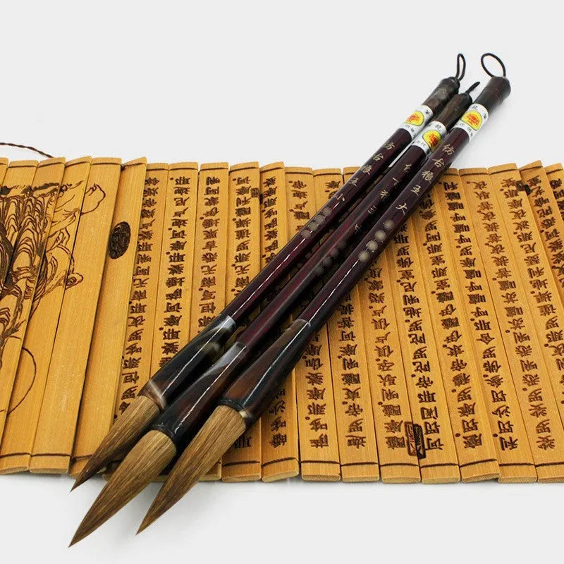Traditional Chinese wolf hair calligraphy brush with steel rod, shown in large, medium, and small sizes.