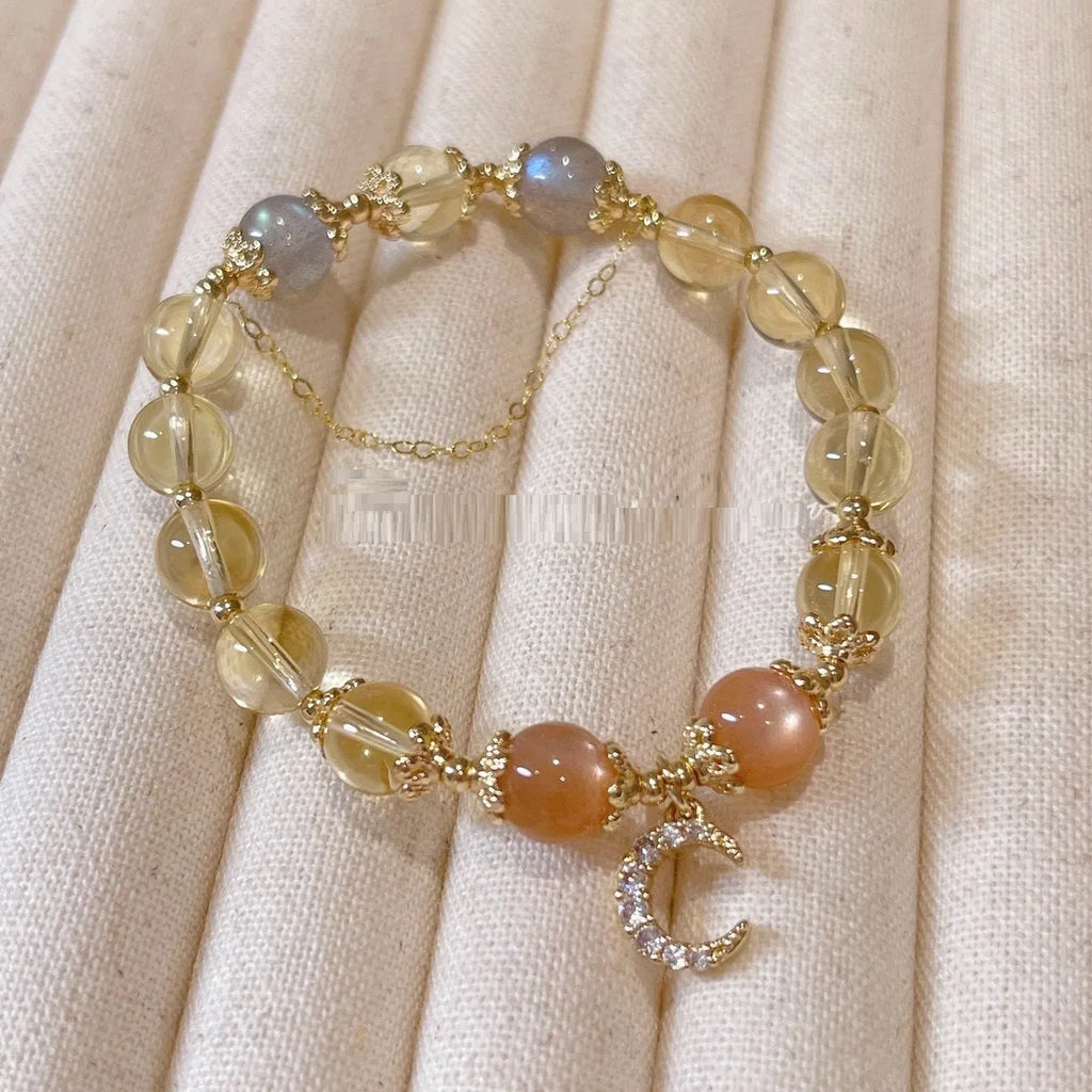 Chinese style crystal bracelet with diamond-shaped stones and gold electroplated finish.