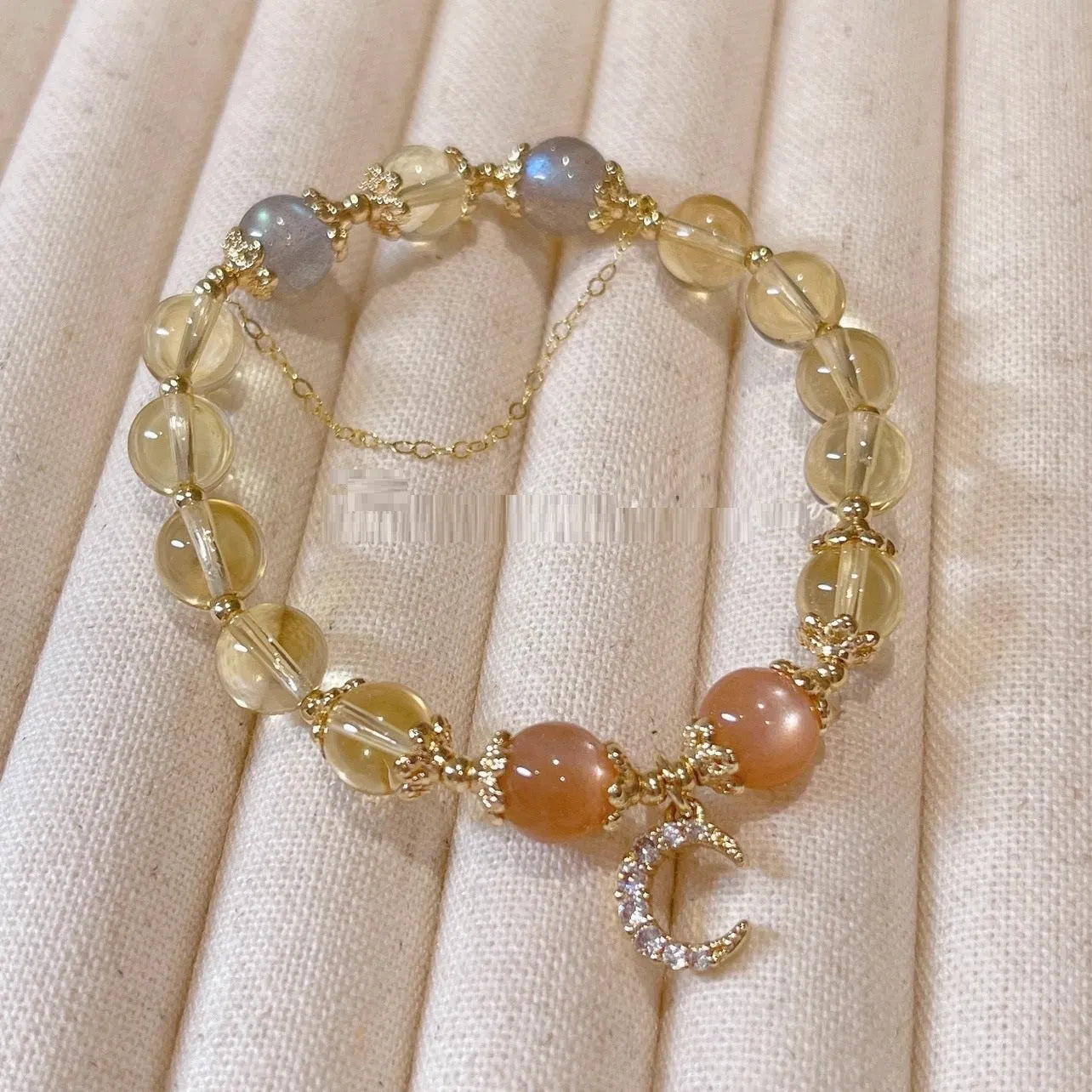 Chinese style crystal bracelet with diamond-shaped stones and gold electroplated finish.