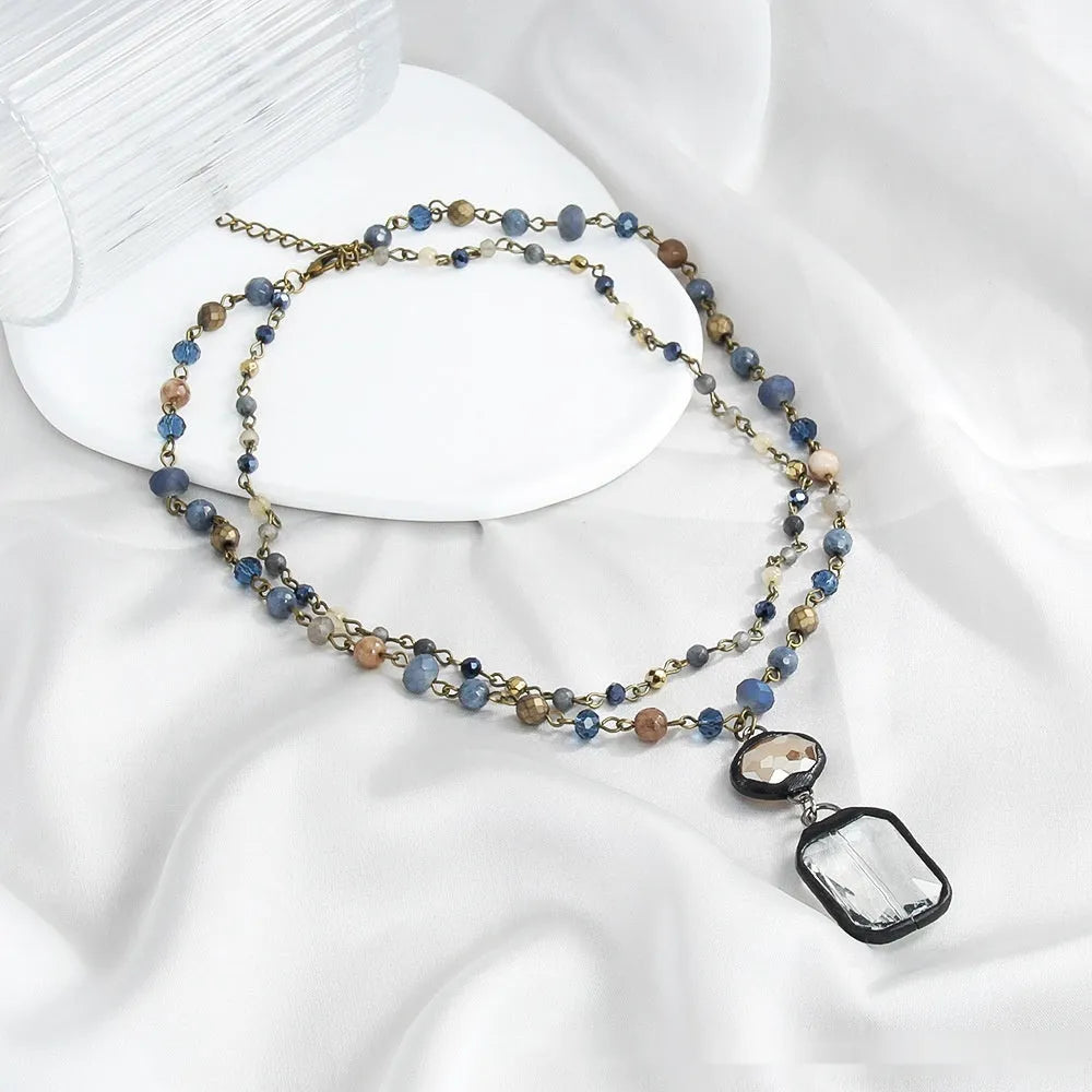 Retro tribal style 2-layer necklace with natural stone and glass pendants in beige or blue colour
