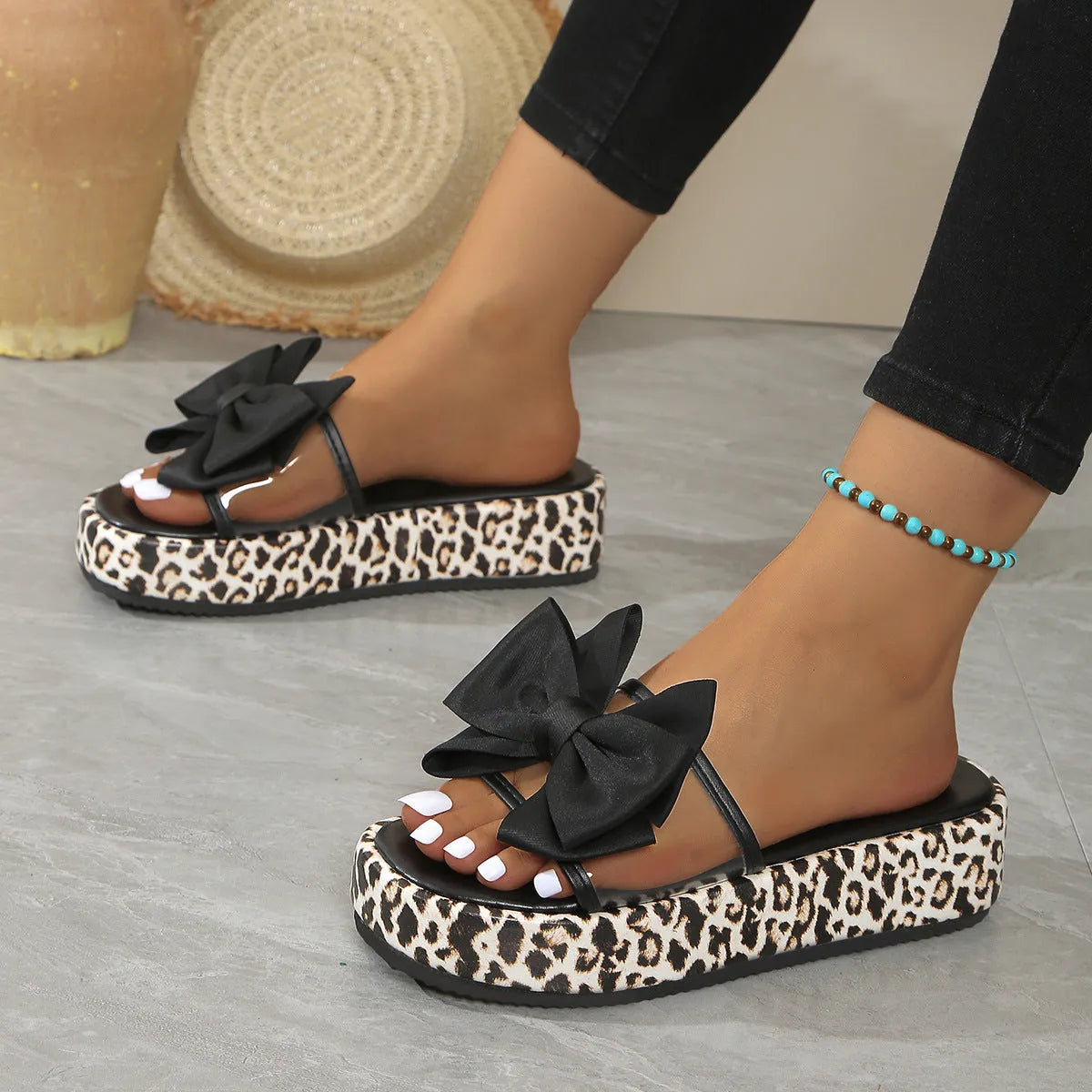 Leopard print women's slippers with thick sole and round toe in black or white.