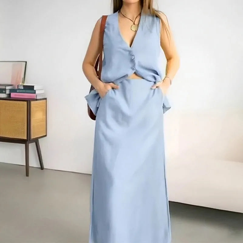 Women's blue polyester two-piece set with sleeveless vest and long skirt on a hanger.