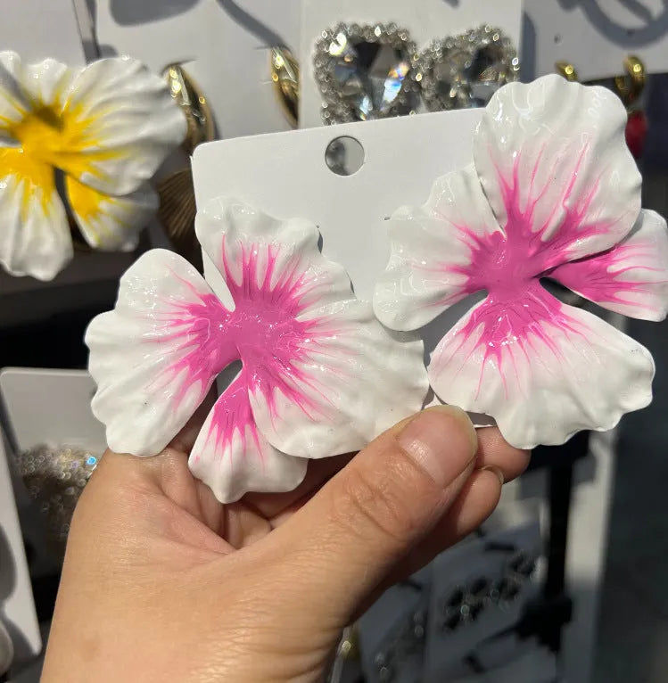 A pair of pastoral style alloy stud earrings with oil-spot glaze floral design in one of four colours.