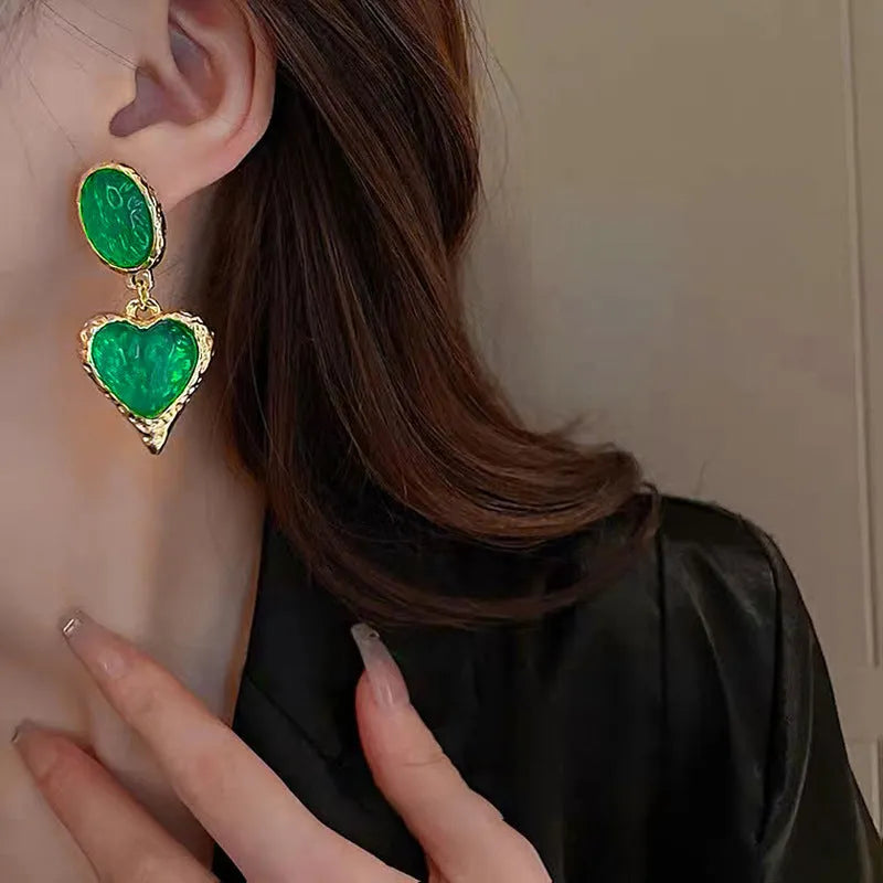 Pleated oval heart stud earrings in alloy showing four colour options