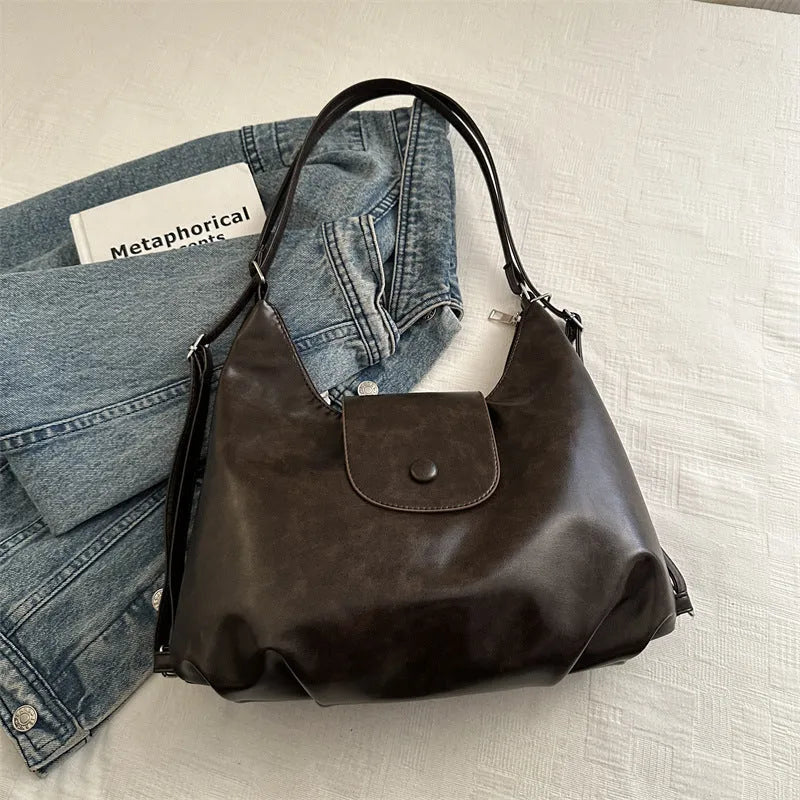 Women's PU leather shoulder bag in horizontal square shape with single strap, showing interior mobile phone compartment