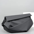 Men's grey PU crossbody chest bag showing zipper opening and adjustable shoulder strap.