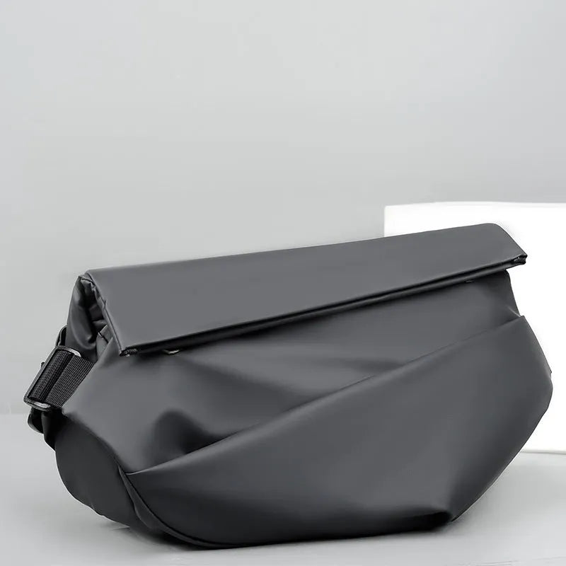 Men's grey PU crossbody chest bag showing zipper opening and adjustable shoulder strap.