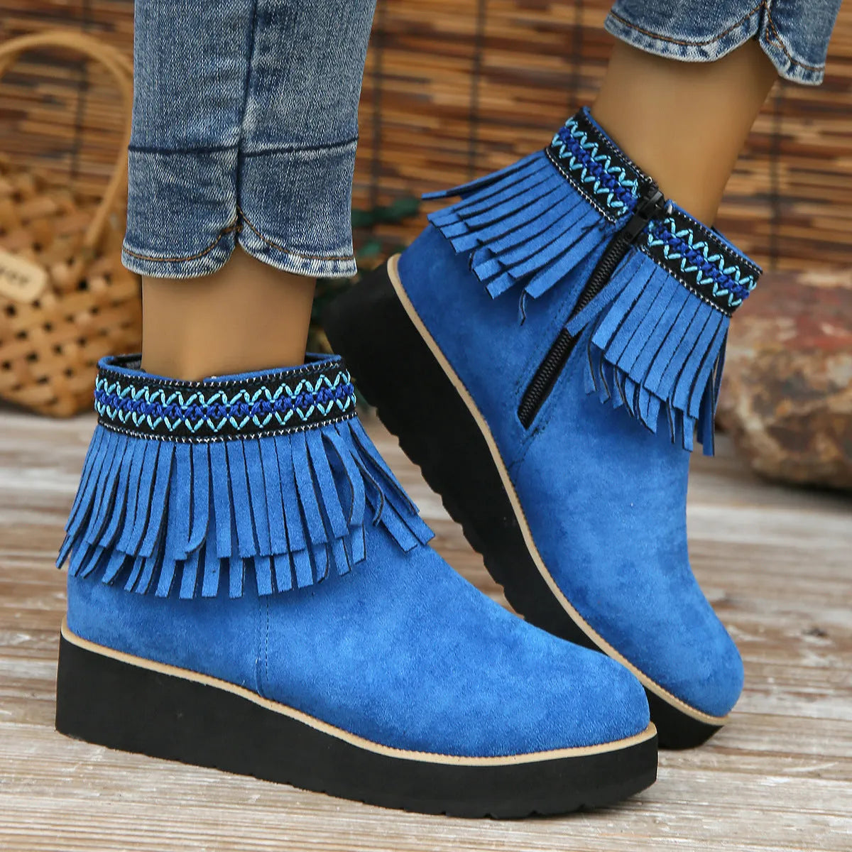 Women's dark brown suede ankle boot with wedge heel, side zipper, and decorative tassel.