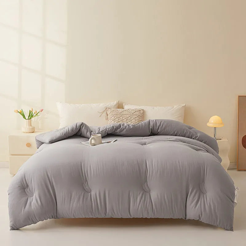 Soybean fibre quilt with pure cotton cover in grey colour on a bed.