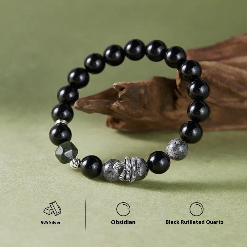 Men's S925 sterling silver bracelet with a black obsidian snake charm on a dark background.