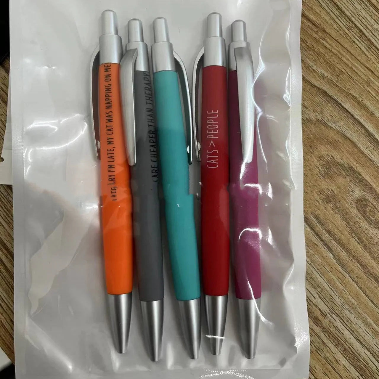 Five coloured automatic pens with push action mechanism in beaded storage bag with cat and dog refill packs