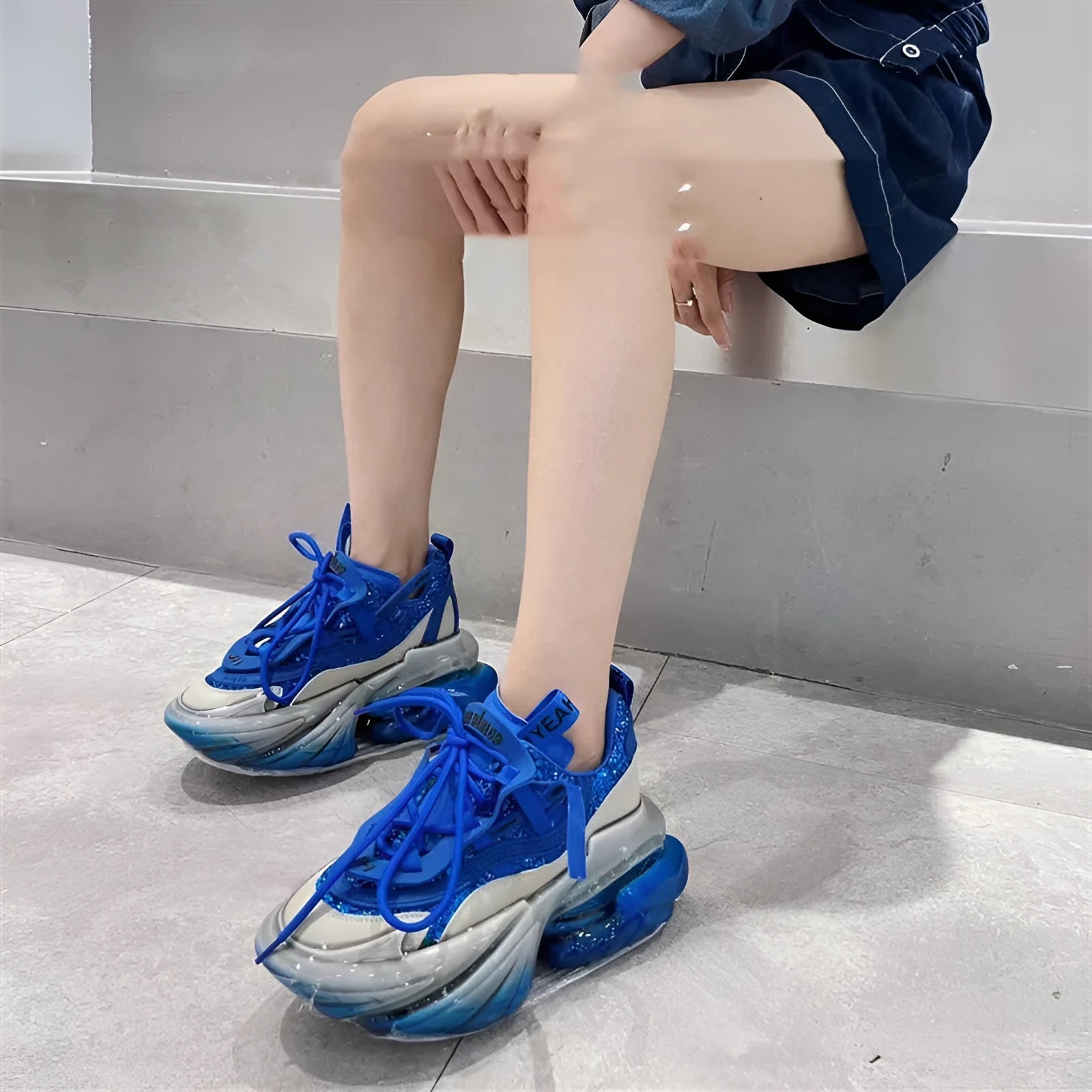 Women's leather sports shoes with a thick jelly sole and white cross-tie fastening on a round toe.