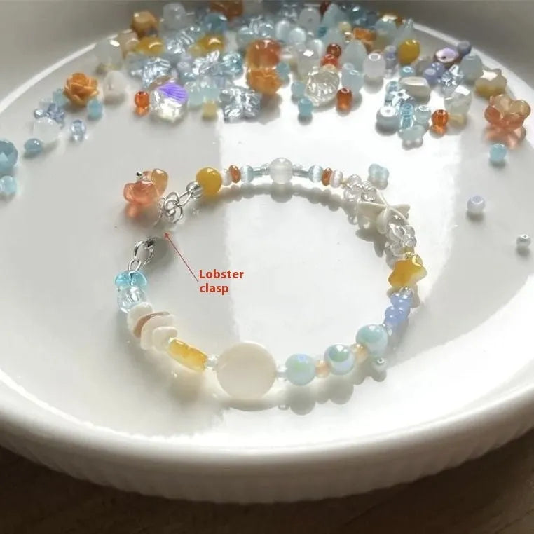Orange alloy bracelet with diamond-shaped links and round decorative elements for women