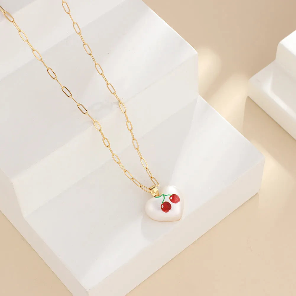 Geometric heart fruit pendant necklace with adjustable chain showing strawberry, pineapple, apple designs