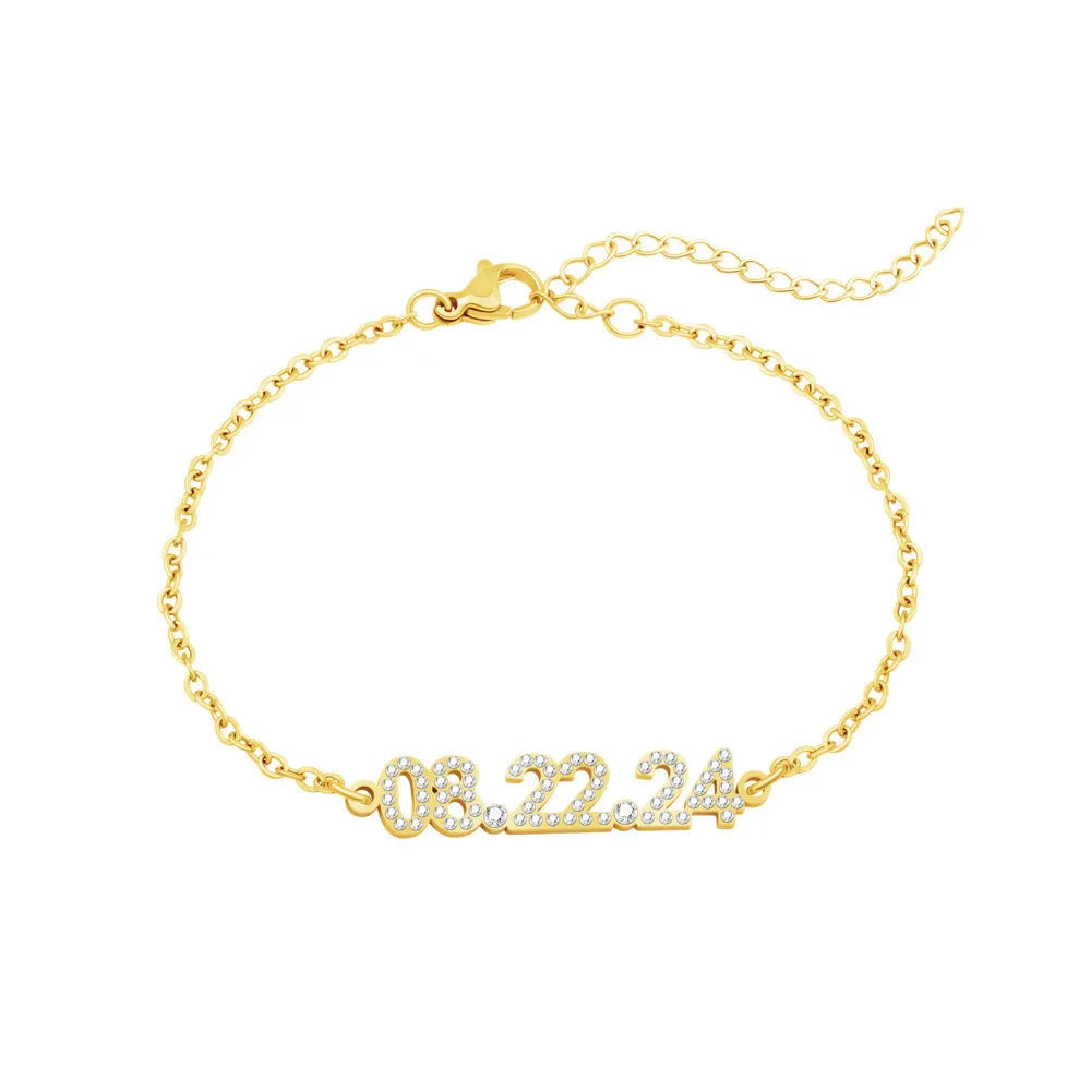 Stainless steel digital bracelet with crystal-set numbers on dial, shown in gold colour.