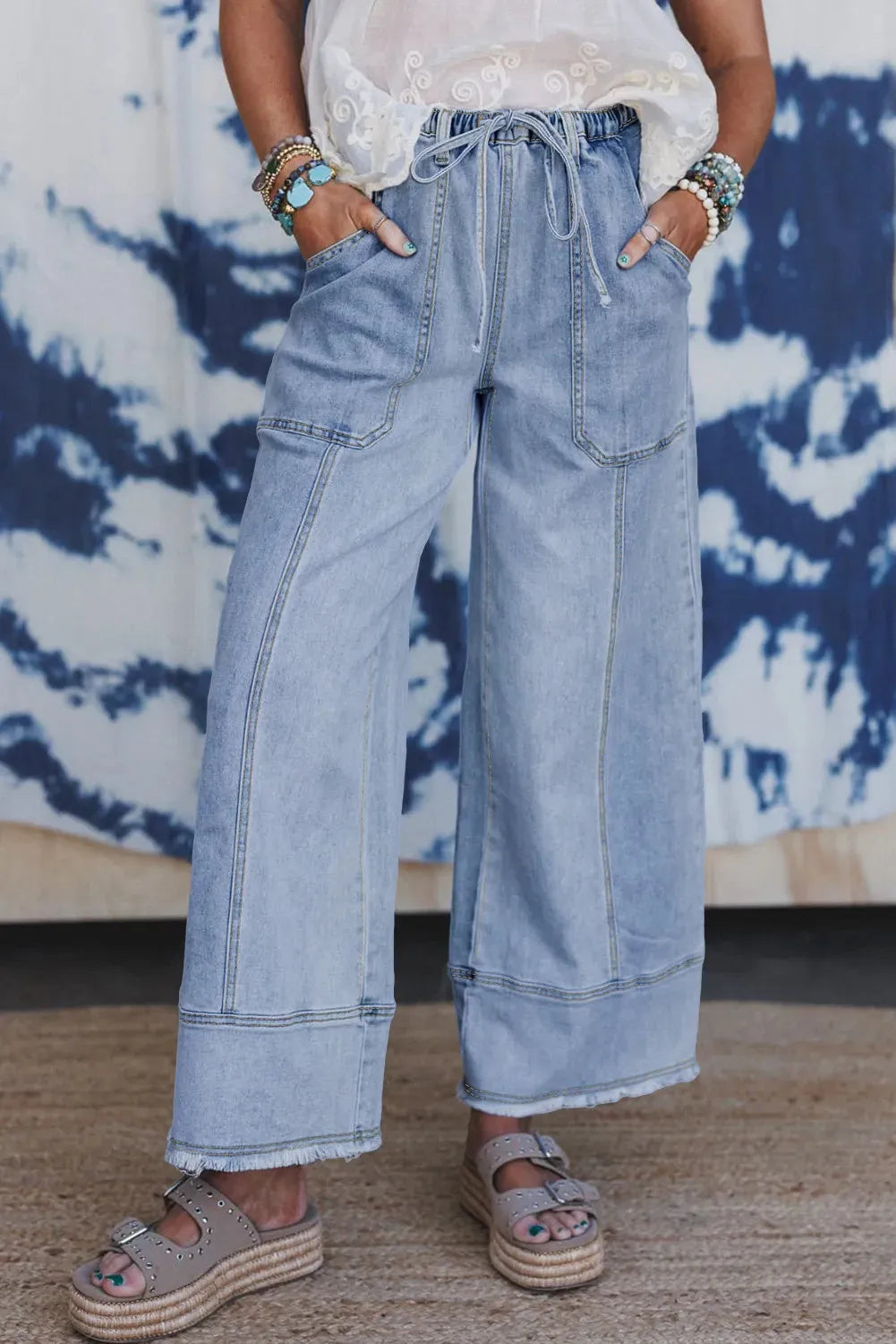 Beau Blue wide leg denim pants with drawstring waist and raw hem detailing laid flat