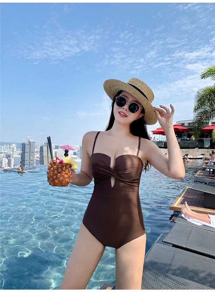 Simple solid colour one-piece swimsuit with push-up design and spaghetti straps