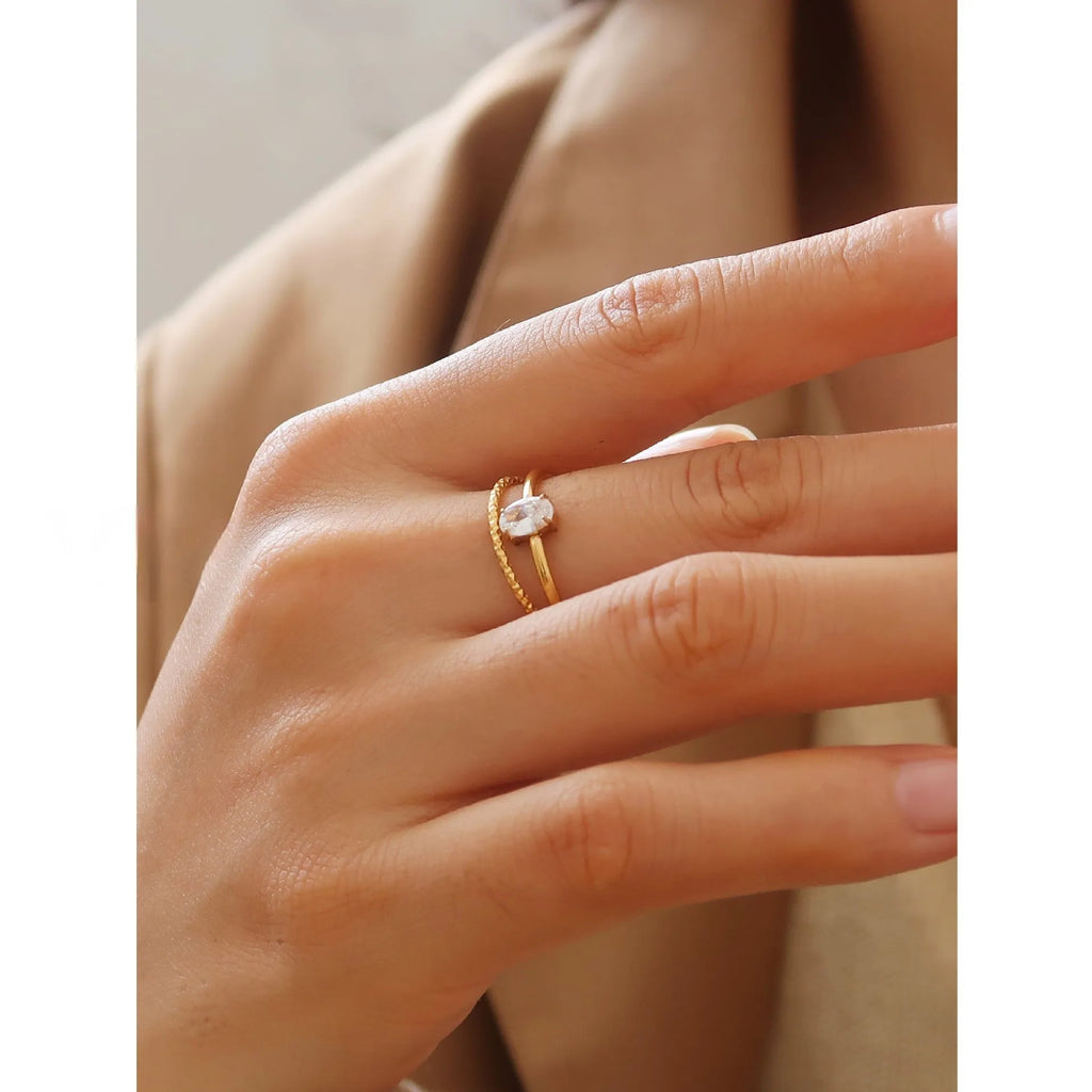 Golden stainless steel ring showing love heart and oval shape options, displayed next to size markers 5, 6, 7, 8.