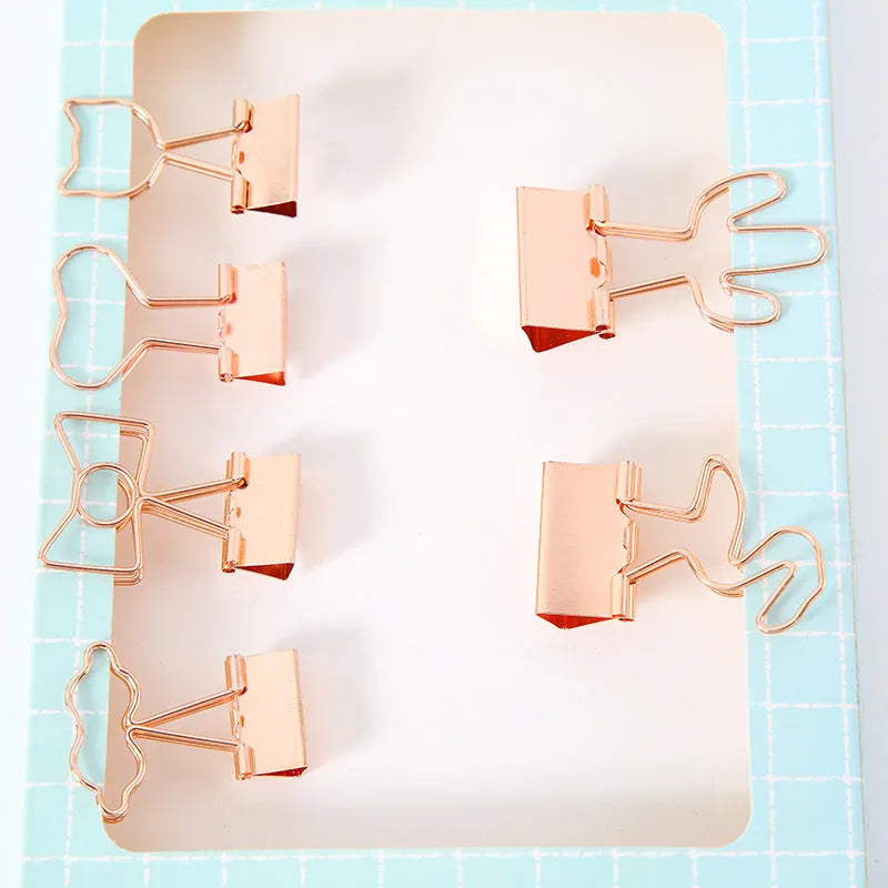 Gold-plated decorative binder clips showing flamingo, love, clouds, cat, cactus and bow designs