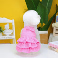 Small dog wearing candy layered skirt princess dress in rose red colour