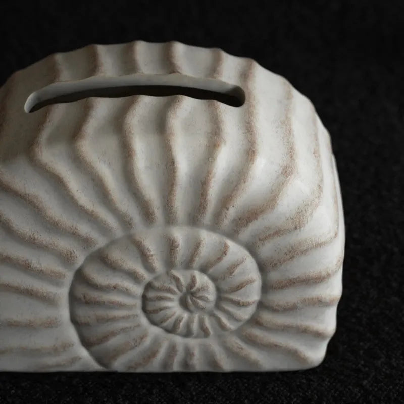 Conch ramble coloured resin decorative tissue box cover with a modern simple design.