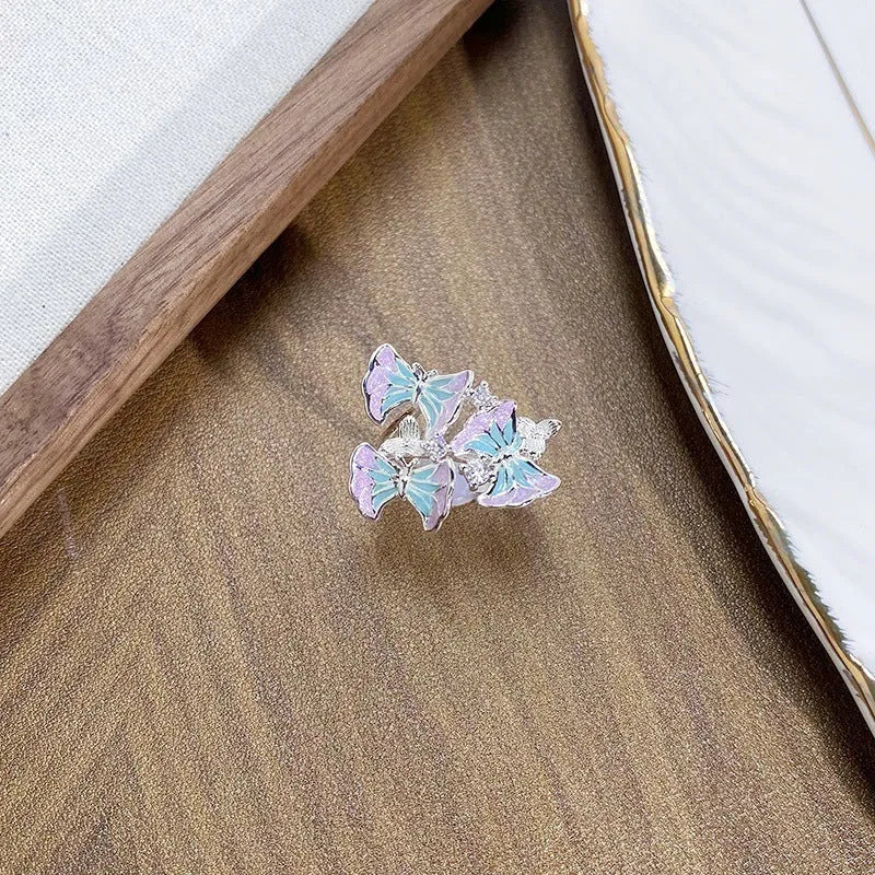 Copper adjustable insect ring with dripping oil finish in jewellery display
