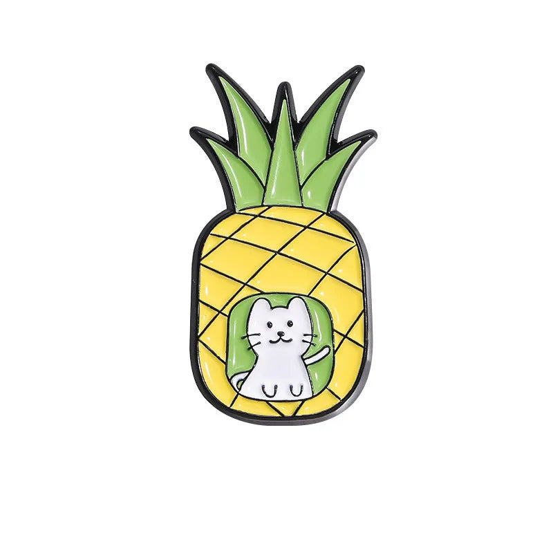Colourful cartoon fruit design metal brooch with pin back on a fabric background.