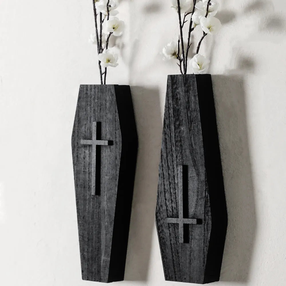 Black cross-shaped wooden wall shelf for home decoration, measuring 27 by 9 centimetres.