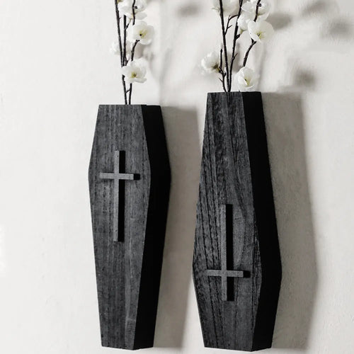 Black cross-shaped wooden wall shelf for home decoration, measuring 27 by 9 centimetres.