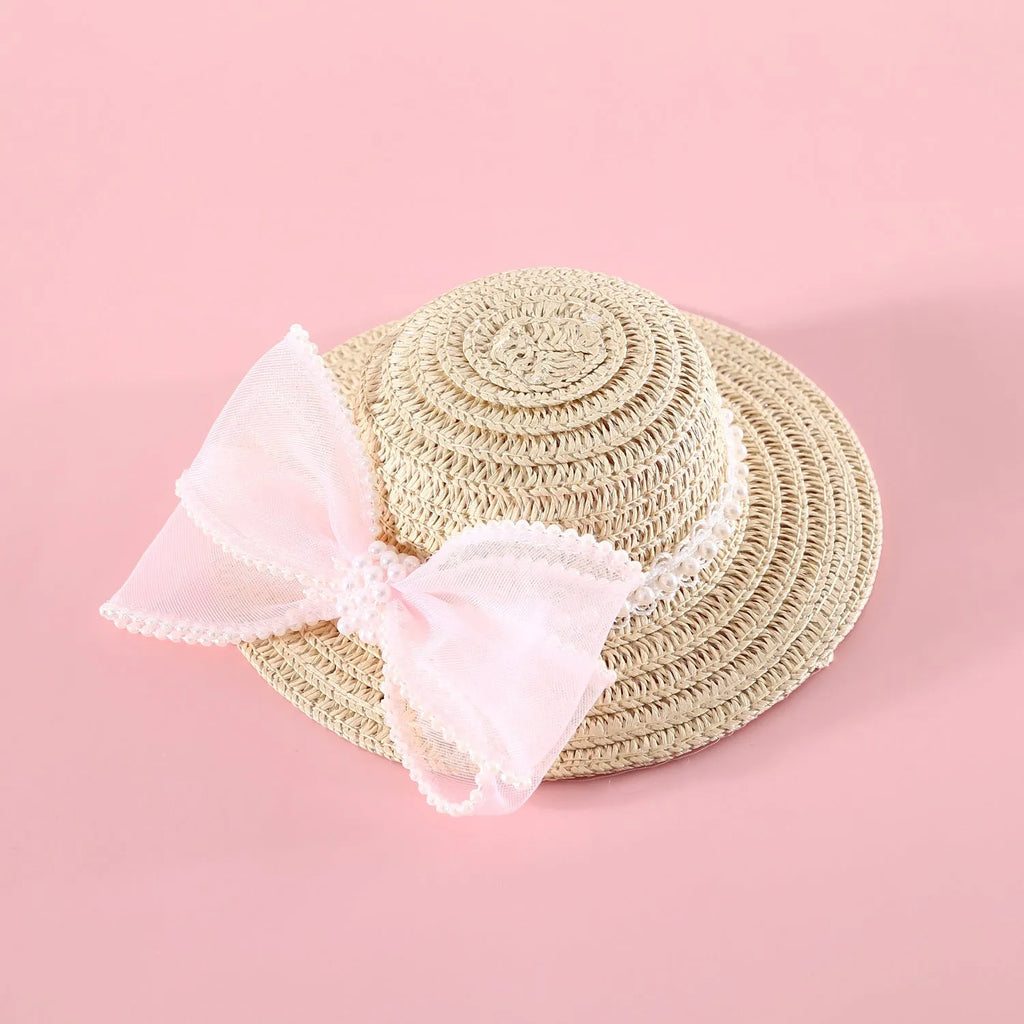 A woven Lafite leaf straw hat for a cat, decorated with a pearl butterfly bow, shown in pink, purple, blue, and white colour options.