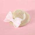 A woven Lafite leaf straw hat for a cat, decorated with a pearl butterfly bow, shown in pink, purple, blue, and white colour options.