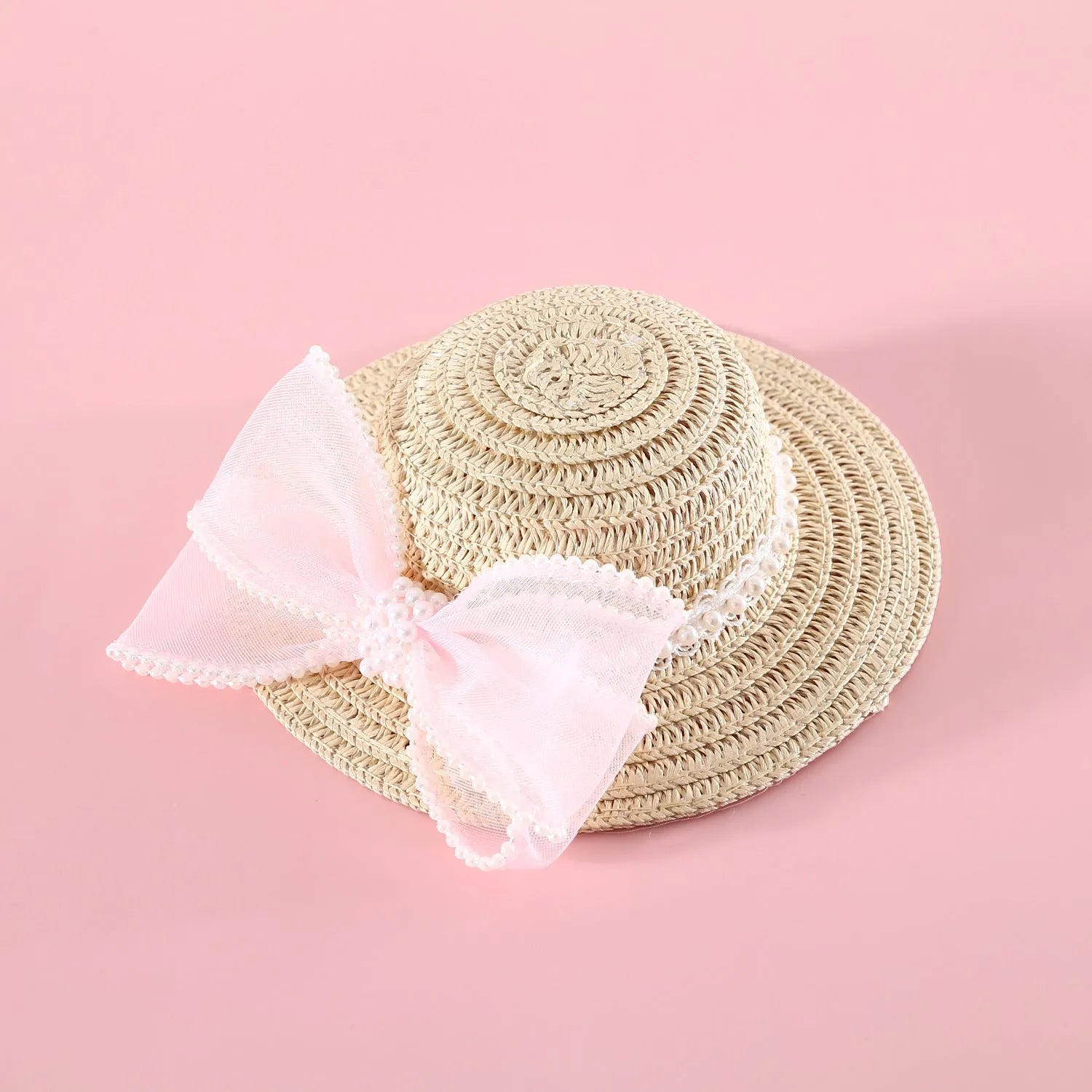 A woven Lafite leaf straw hat for a cat, decorated with a pearl butterfly bow, shown in pink, purple, blue, and white colour options.