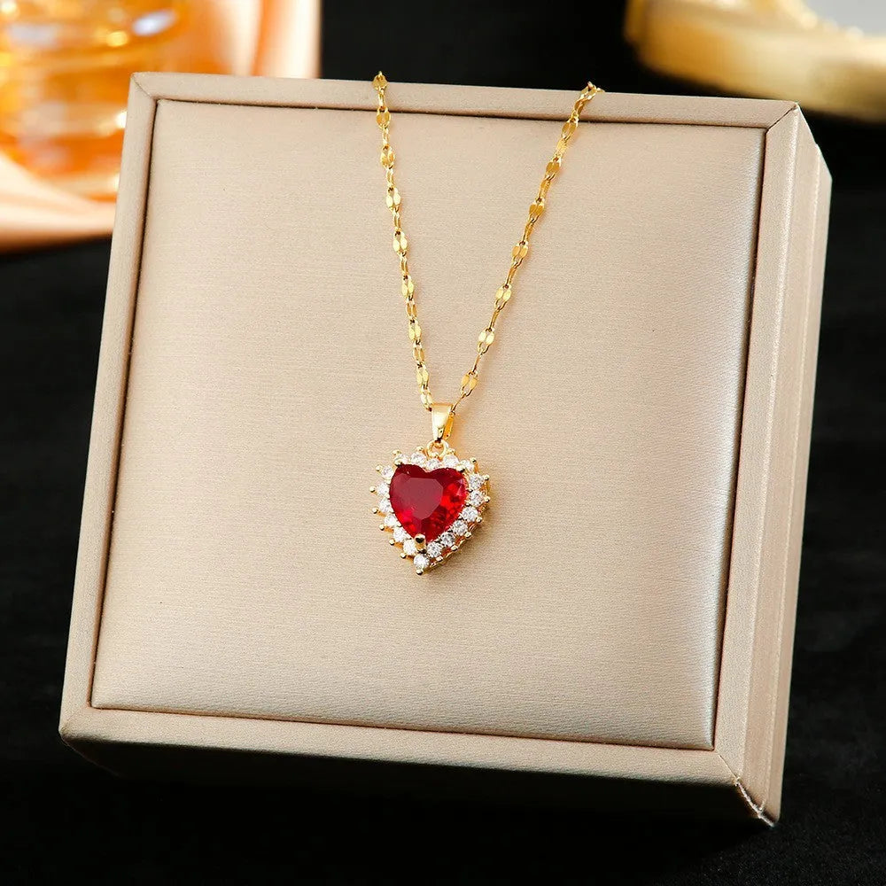 Gold red titanium steel jewellery set with heart flower pendant, matching earrings and ring