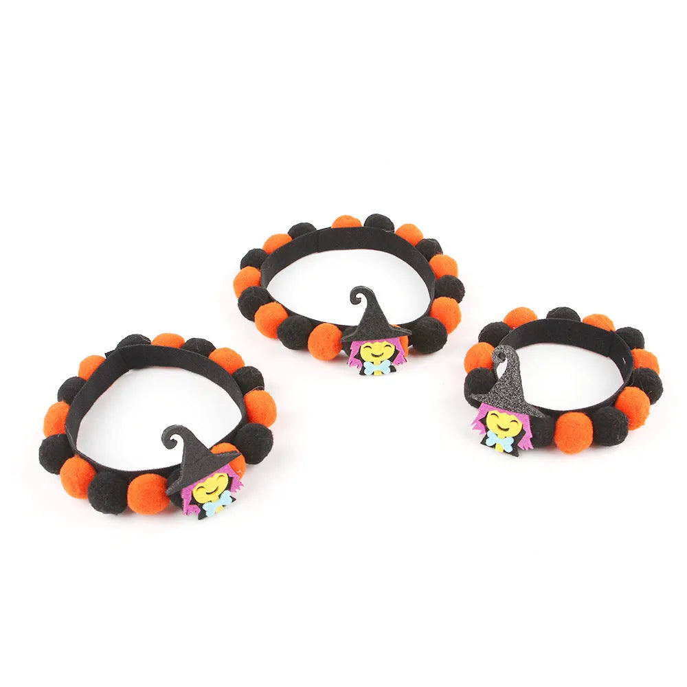 Halloween pet collar with soft fur ball pumpkin accessory in orange, sized on a dog's neck.