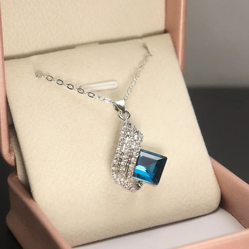 Electroplated alloy necklace and earring set with glass pendant and cross chain design