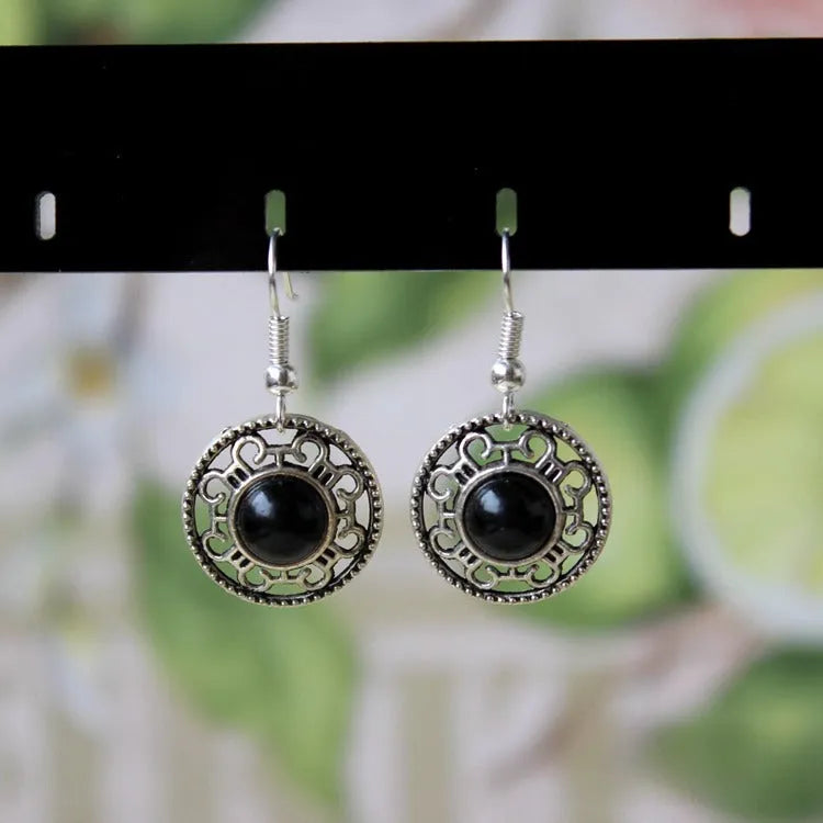 Handmade geometric flower disk earrings in Tibetan silver and turquoise with auspicious cloud patterns.